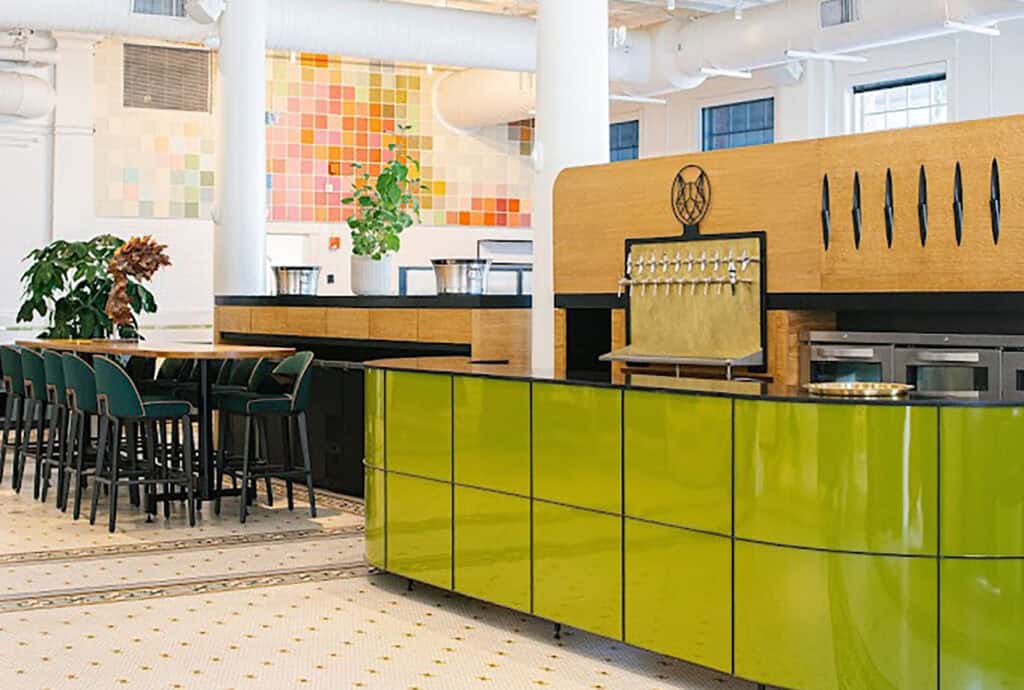 a large transparent green counter top with art on the walls in the background.