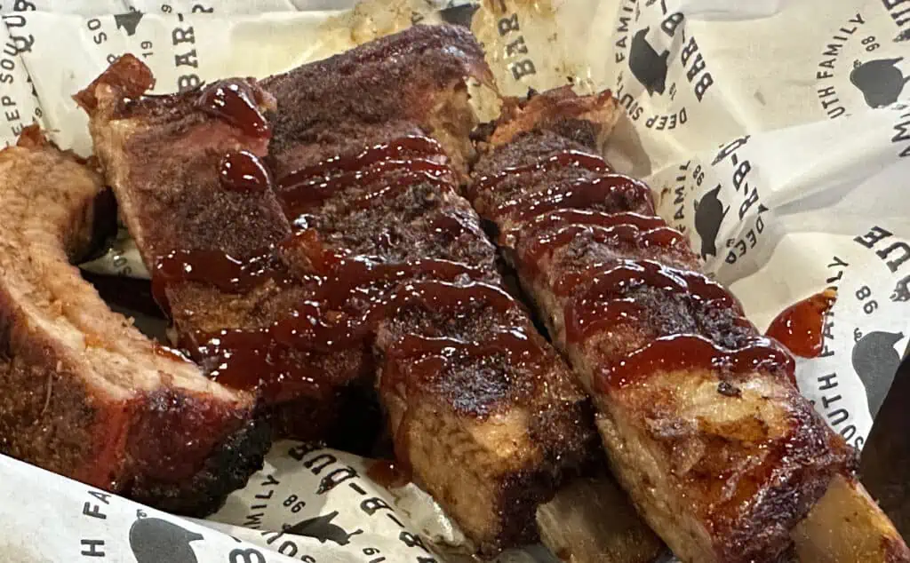 a plate of ribs with bbq sauce