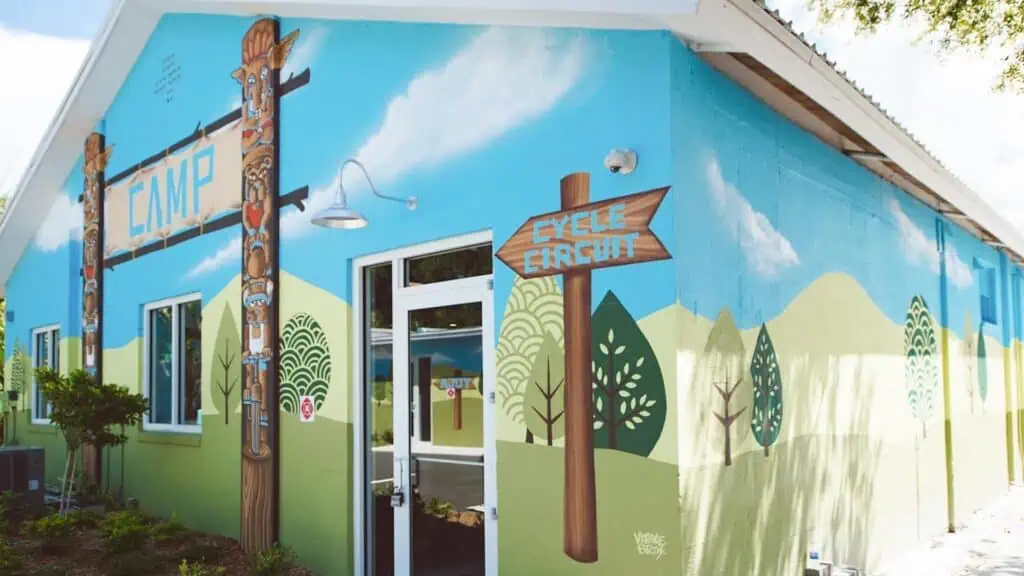 exterior of a gym with blue and green mural
