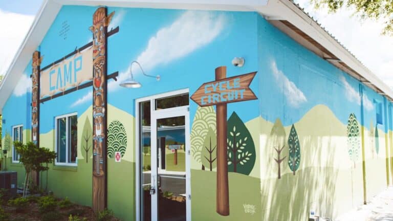 exterior of a gym with blue and green mural