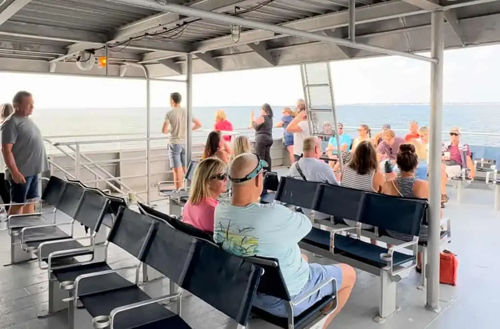 guests sitting on the top deck of a ferry