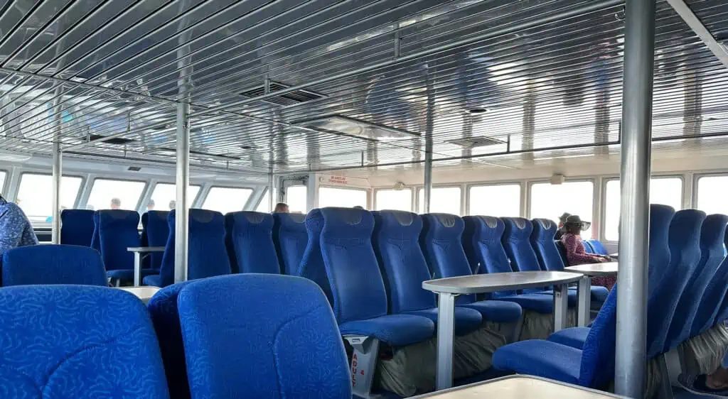 blue seats inside a large ferry