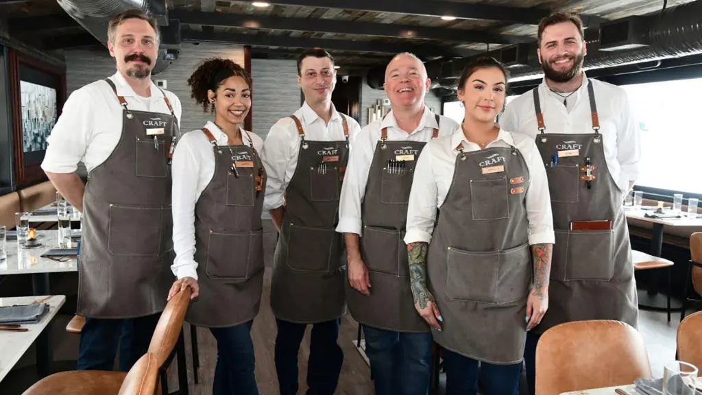 a grouper of chefs and serves on a fine dining cruise