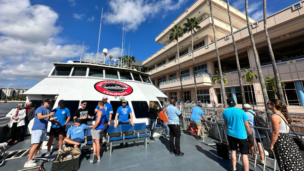 exterior of a large ferry vessel with guests standing on the front deck