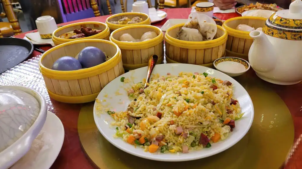a plate of fried rice with multiple dumplings 
