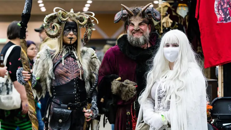 a group of people in distinct costumes gather for a large convention