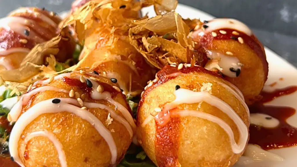 a plate of fried seafood with multiple sauces on top