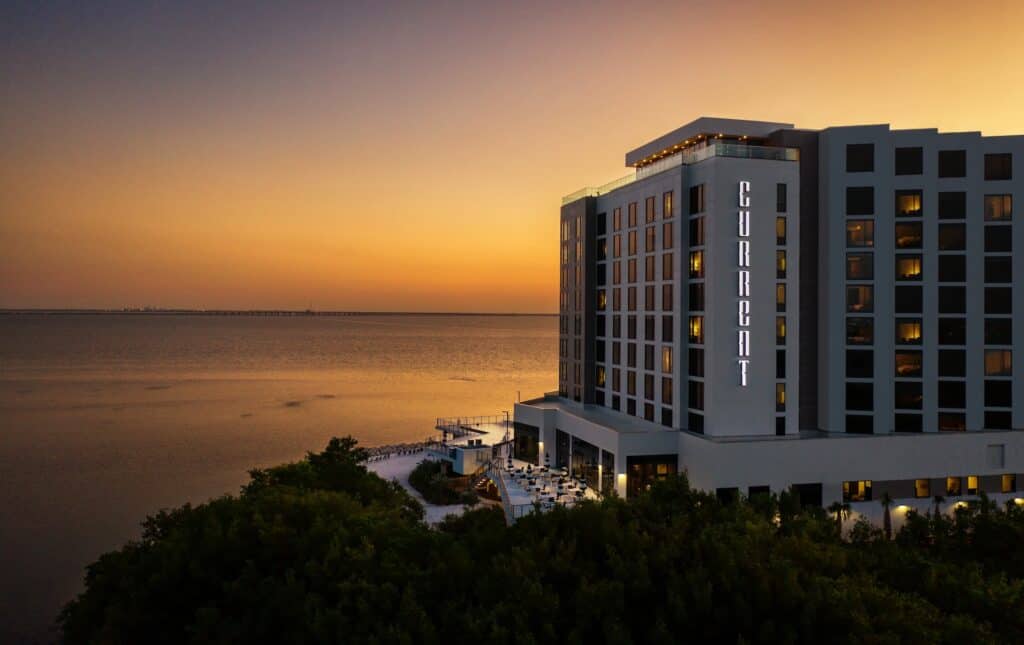 A waterfront hotel photographed at sunset