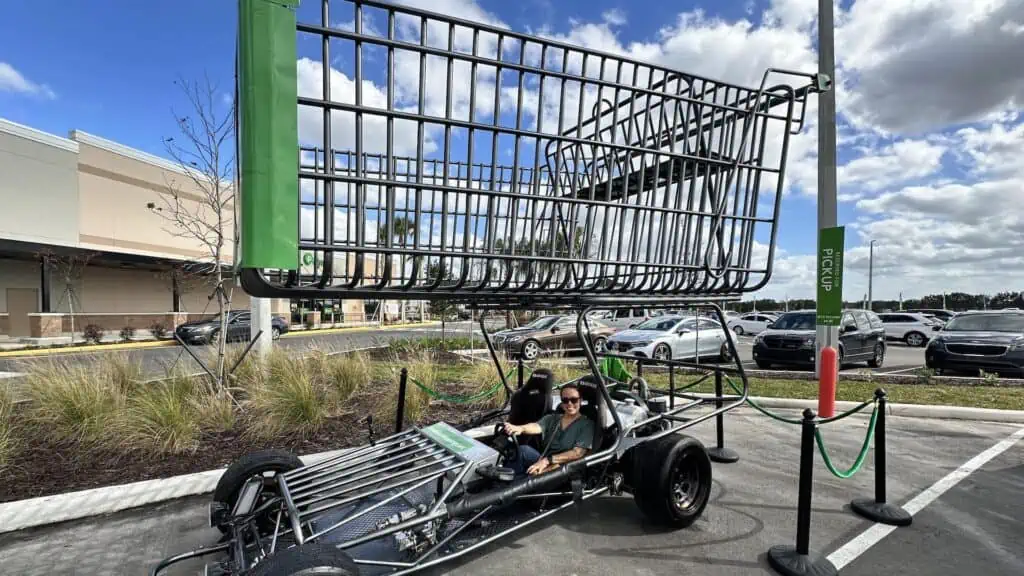 a large shopping cart arranged over a go-kart