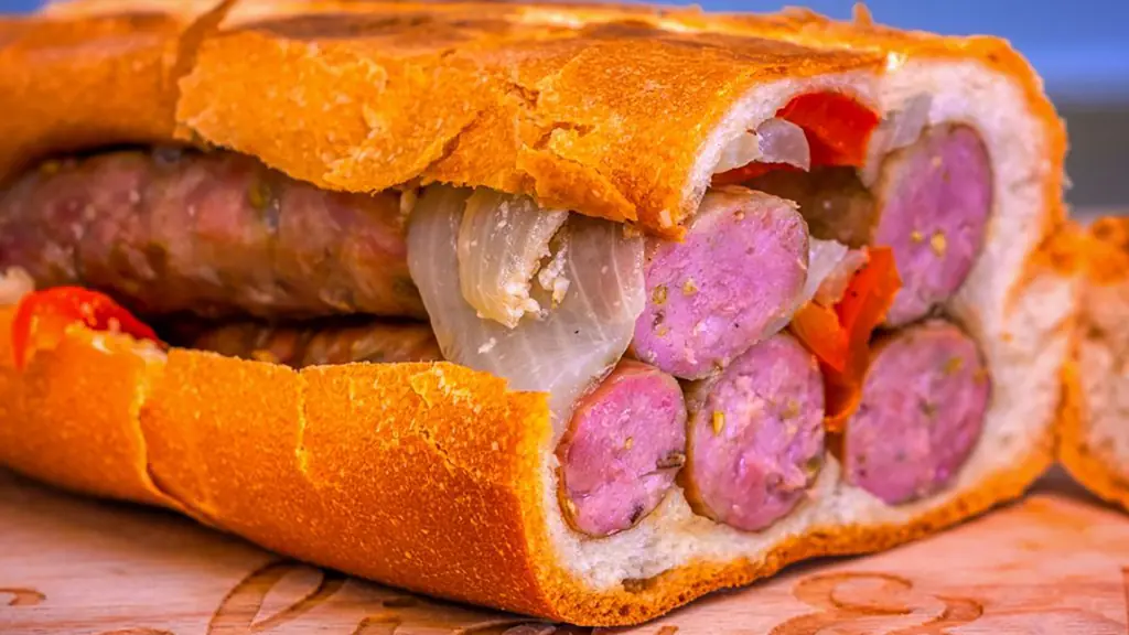 a huge Italian sausage sandwich on pressed Cuban bread