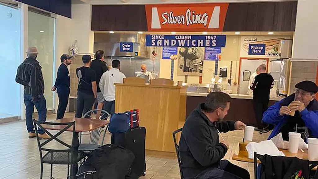 diners in a food court enjoying burgers and sandwiches