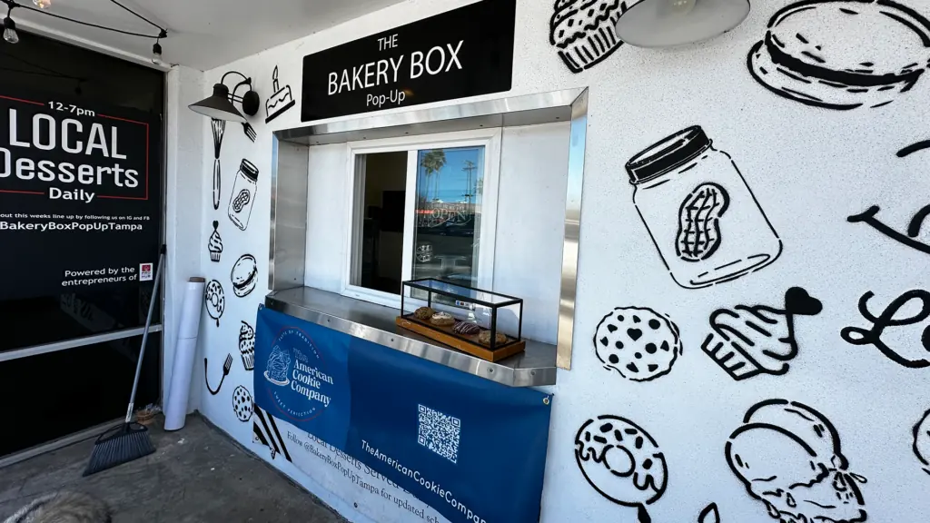 an order window with a big bakery box sign out front