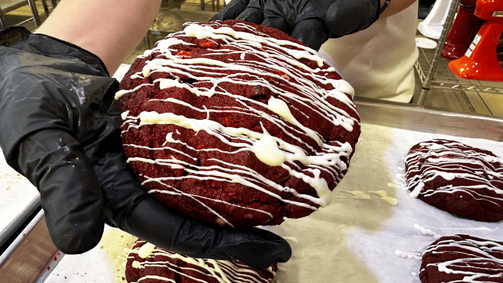 a huge red velvet cookie covered in white chocolate