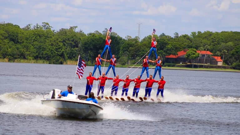 Water Ski performers are stacked on top of one another in a pyramid formation
