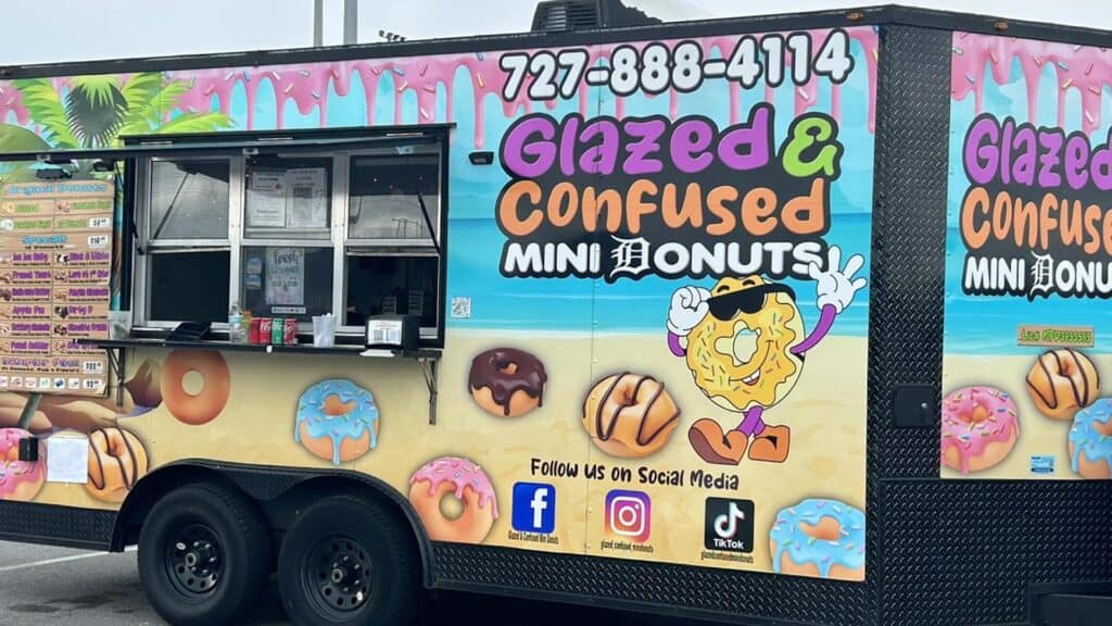 exterior of a food truck decorated with cartoon donuts