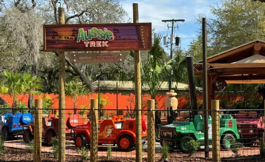 a big safari ride at a zoo. An archway has a sign at the top that reads "Aussie Trek"