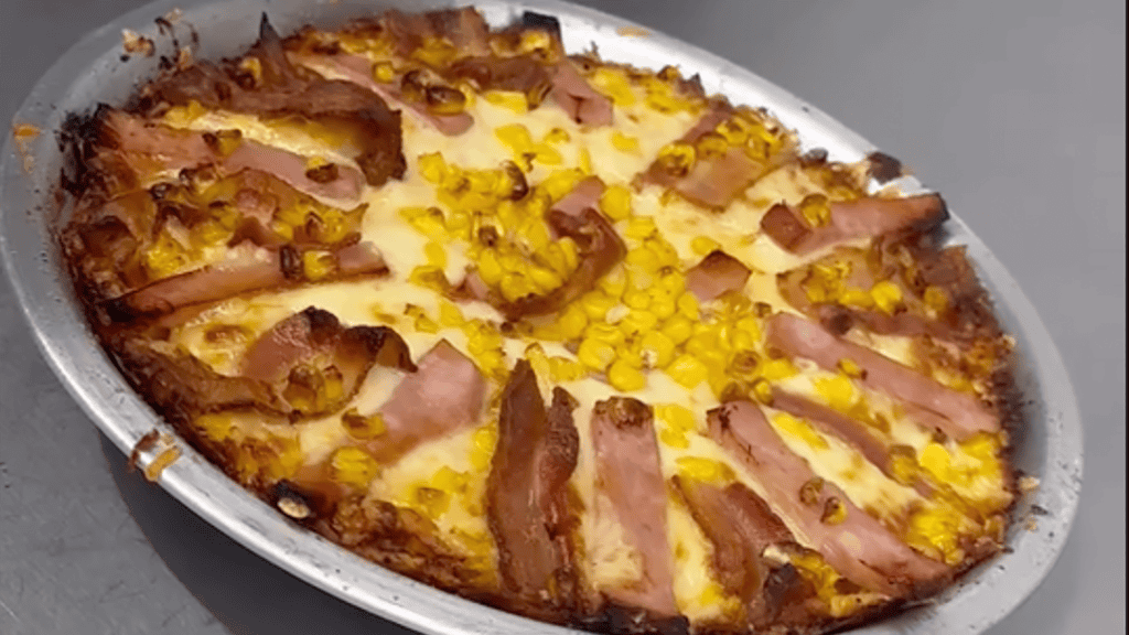 pizza topped with ham and cheese