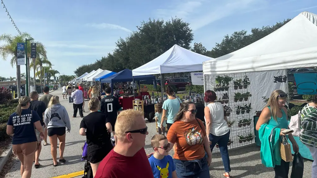 a group of people shop at an open air market