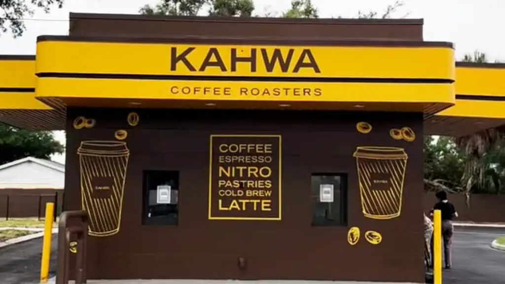 exterior of a coffee drive thru with a brown and yellow paint job