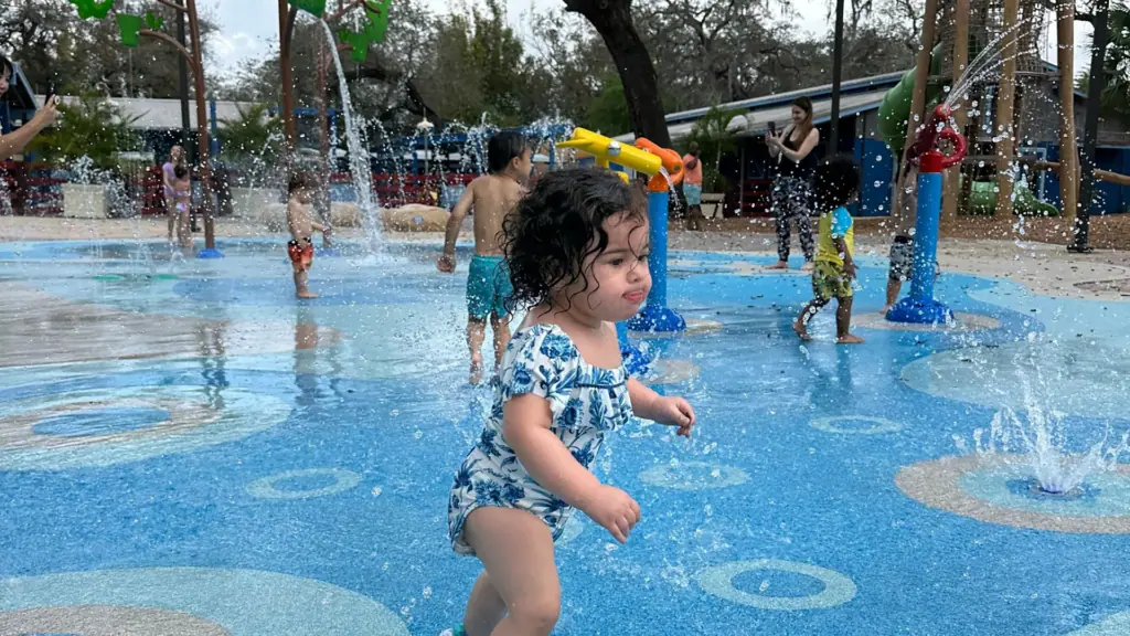 children play in an outdoor splash pad