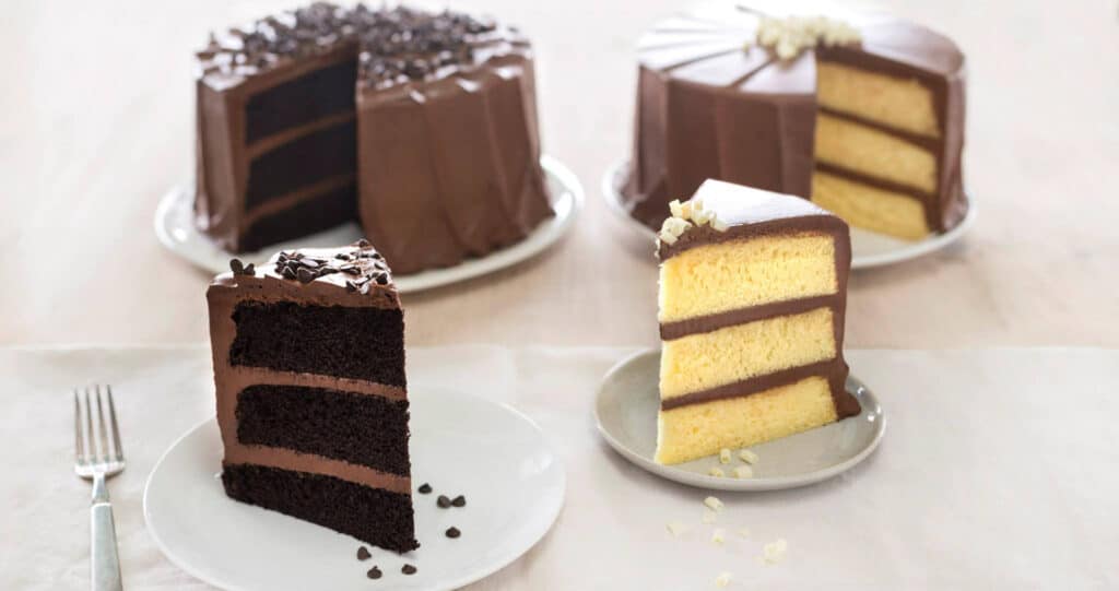 slices of three layer chocolate cake on separate plates