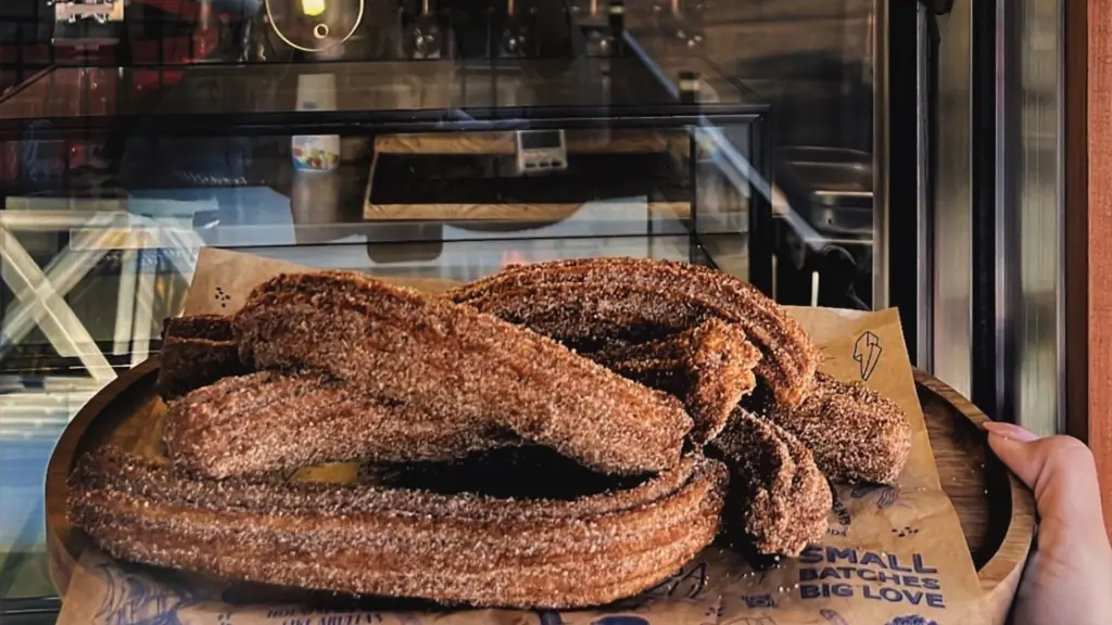 a plate of churros covered in cinnamon sugar