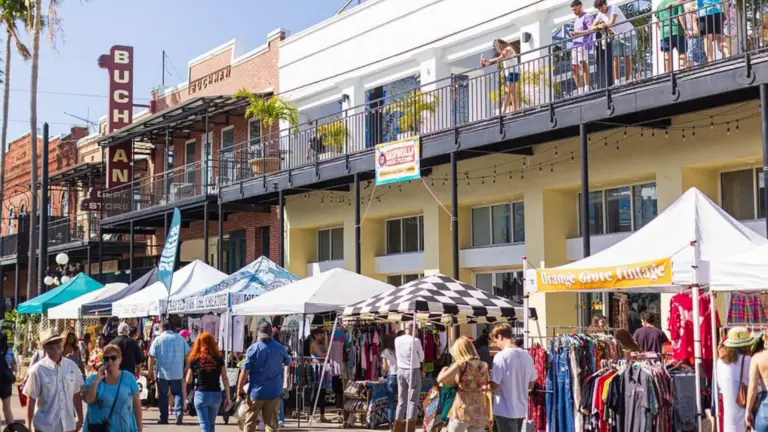 an outdoor shopping event with vendor tensest up outside a historic venue