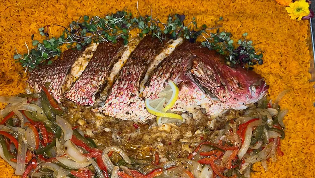 a plate of wild rice and stuffed red snapper