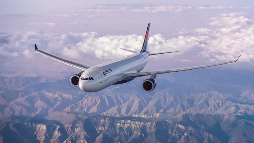 an airplane soars over a mountain range