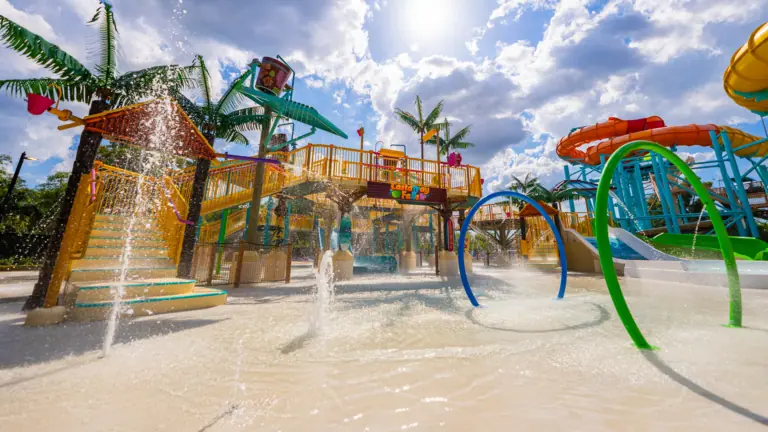 a big splash pad with a playscape