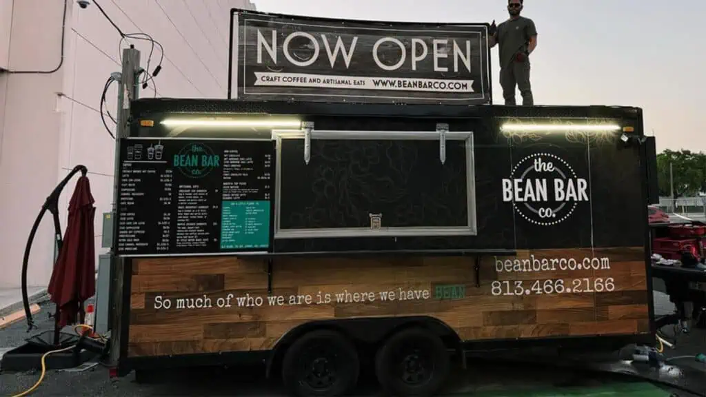 a coffee truck parked in a downtown area