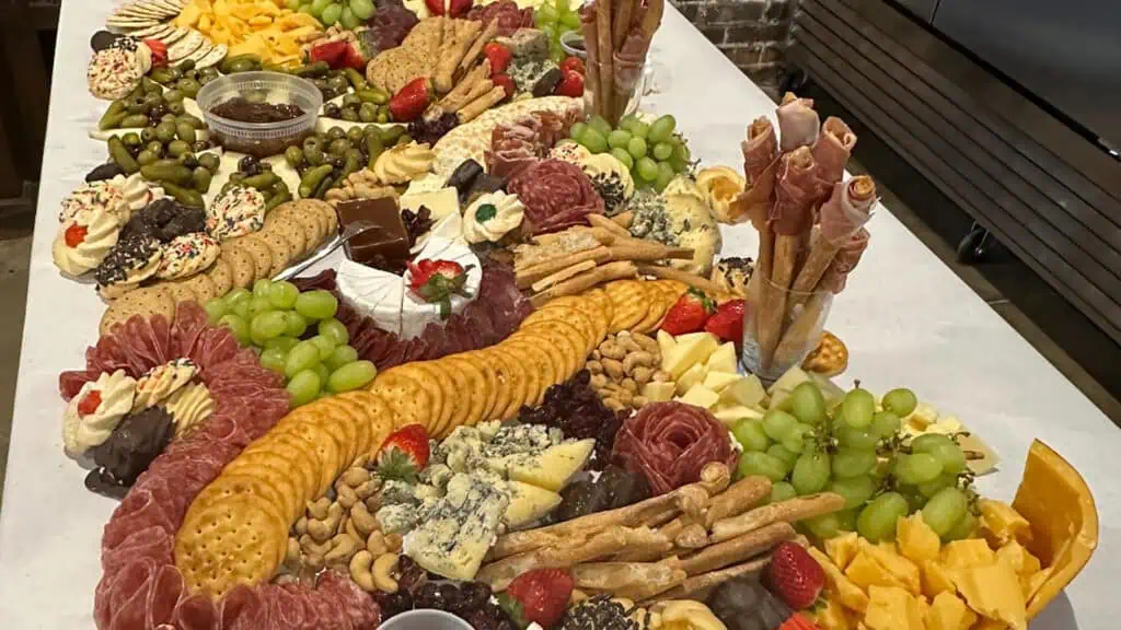 a huge spread of meat, cheese, and crackers at an event