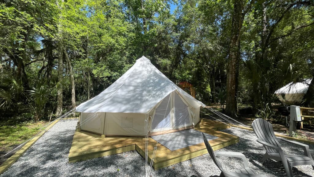 a glamping tent with a large rock patio 