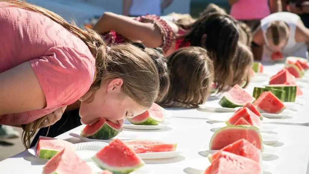 contestants compete in a watermelon eating contest