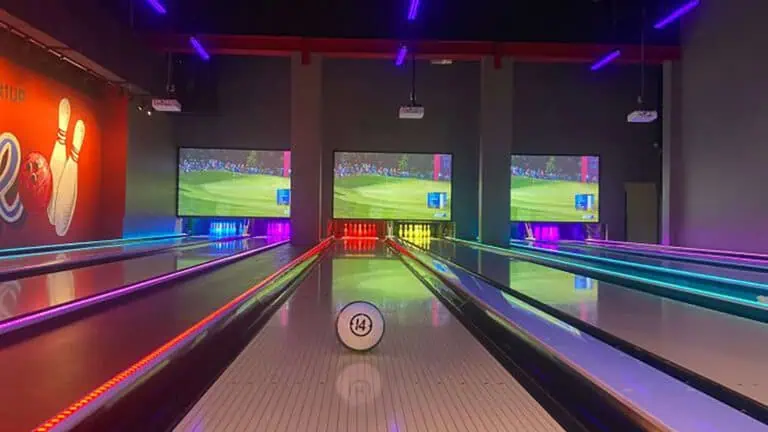 a bowling alley with lanes lit up in different colors