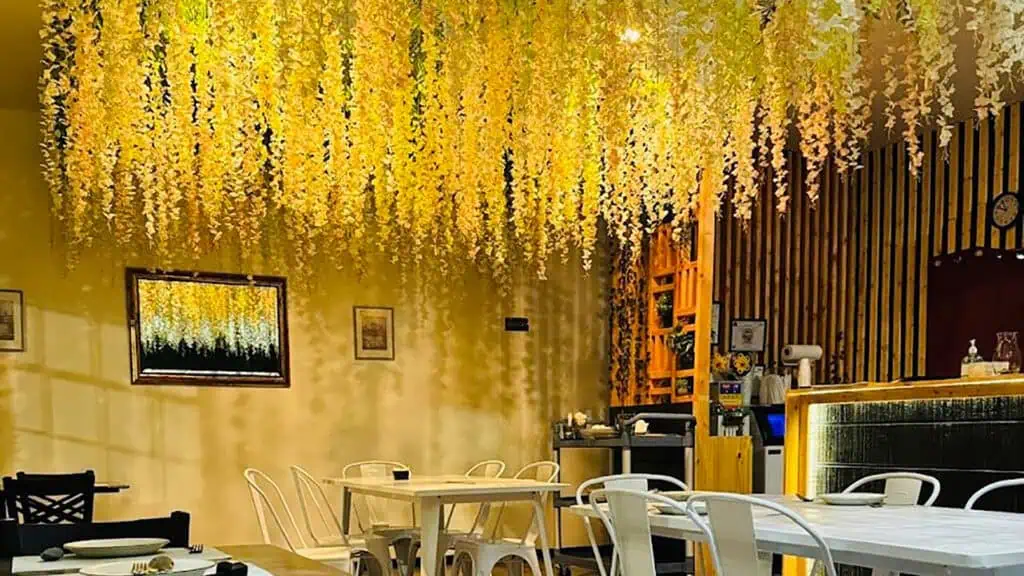 interior of a restaurant with a floral wall decoration