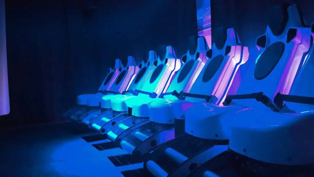 movie theater seats are leaned back and bathed in blue light