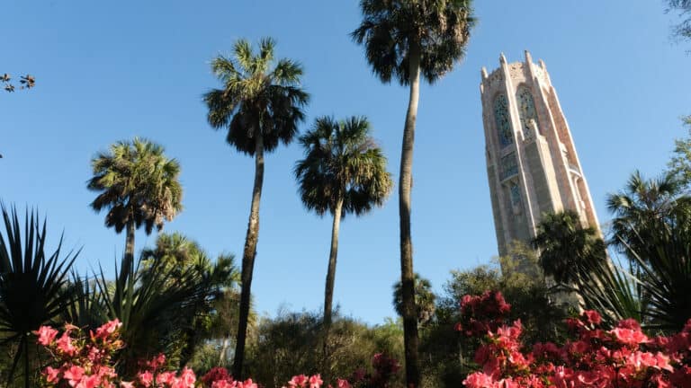 exterior of a beautiful garden with a large bell tower at the center