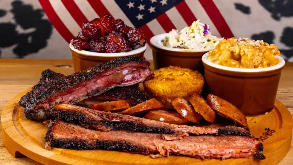 a plate of ribs with multiple sides arranged around it