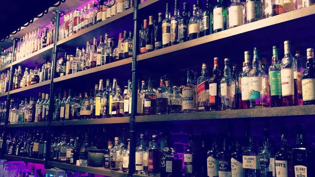 multiple liquor bottles arranged on shelves 