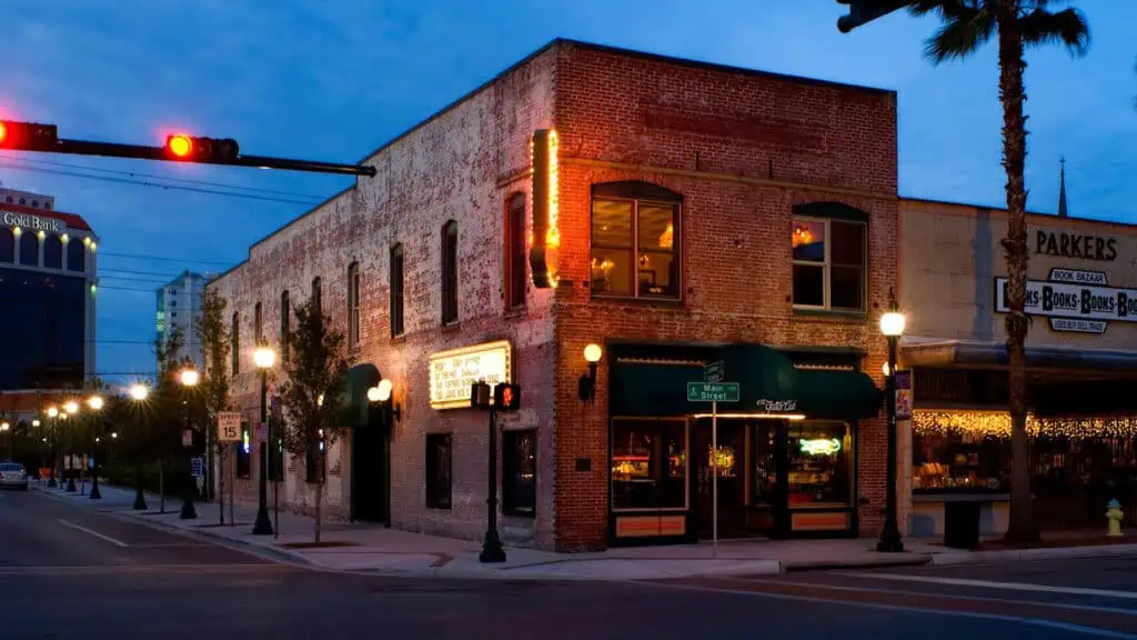 exterior of a brick building with a live music stage inside