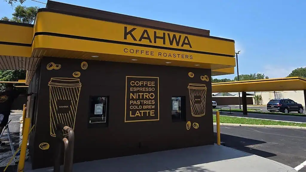 exterior of a drive-thru coffee shop with a brown and yellow paint job