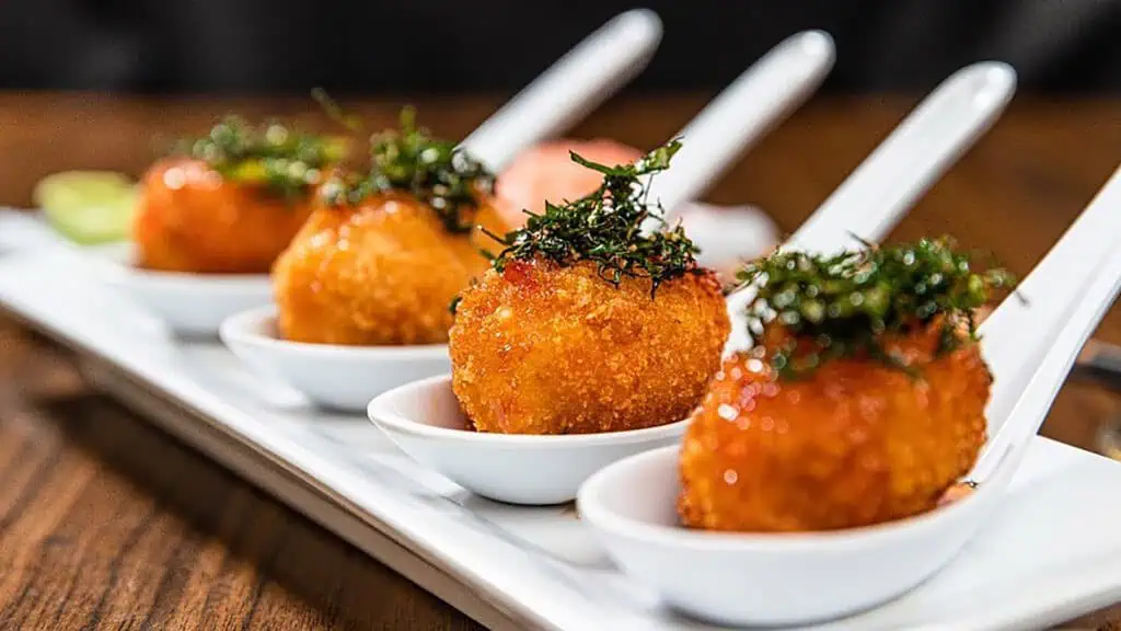 fried fish and rice balls plated and garnished