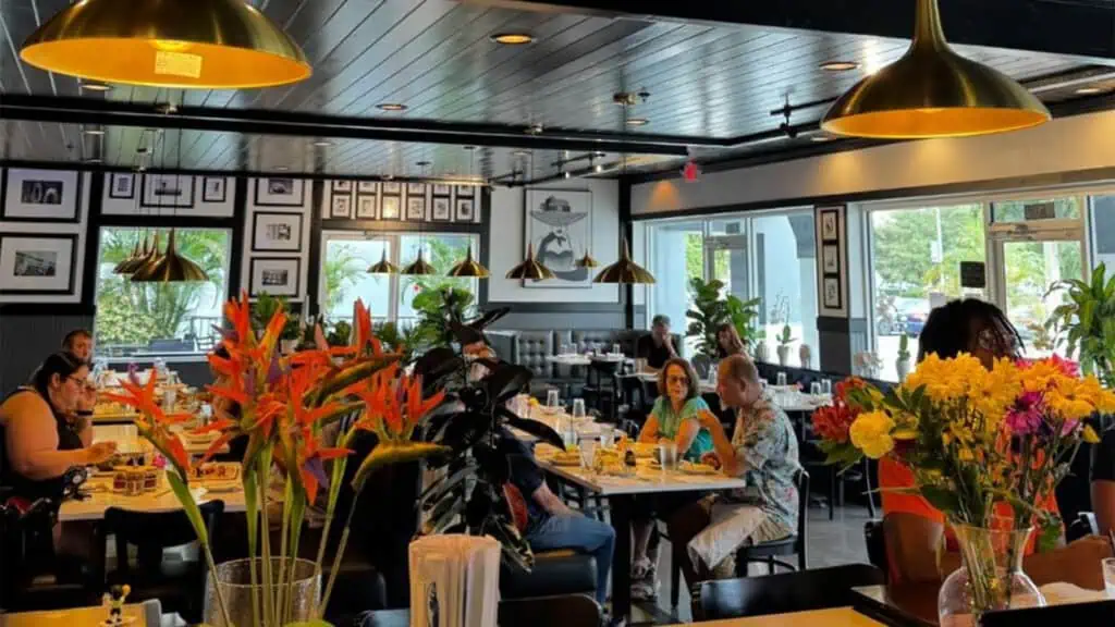 interior of a restaurant with patrons enjoying sushi rolls