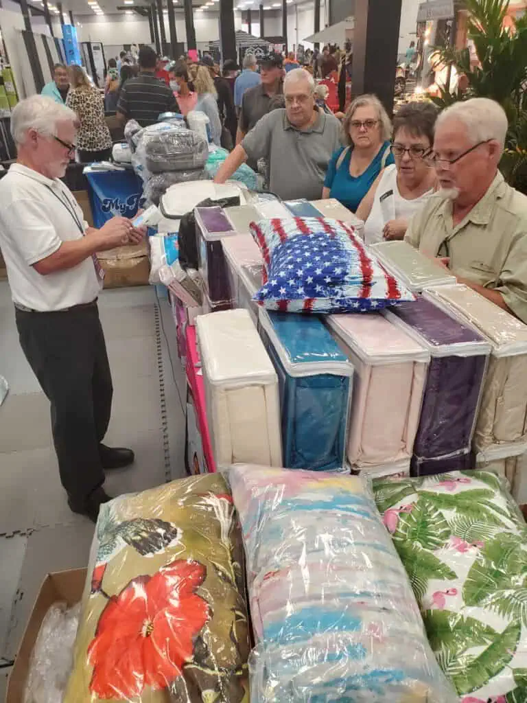 Four older people looking at bedding