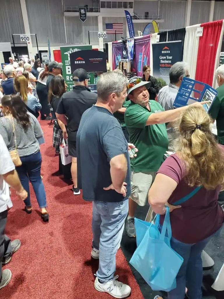 One man pointing at a brochure in front of a couple