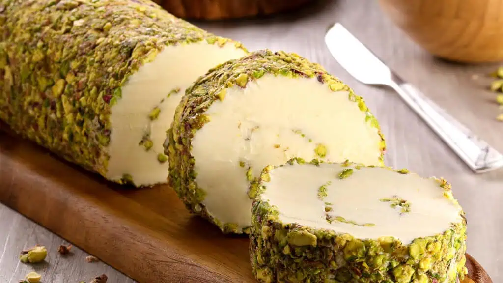 an ice cream roll rolled in pistachios