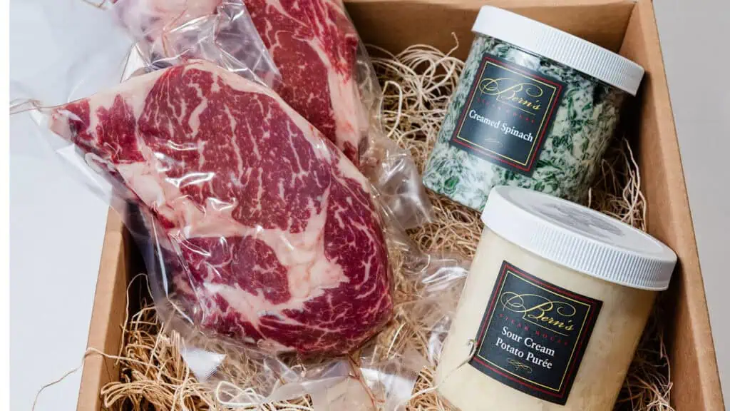 overhead shot of steaks and two pints of ice cream in a shipping box