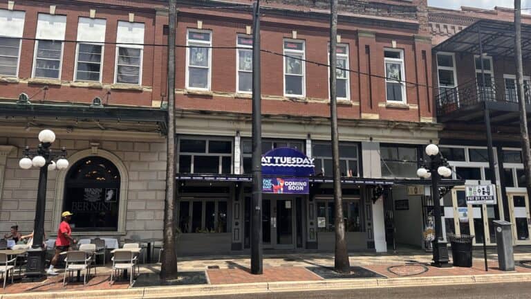 exterior of a bar on the ground floor of a historic brick building