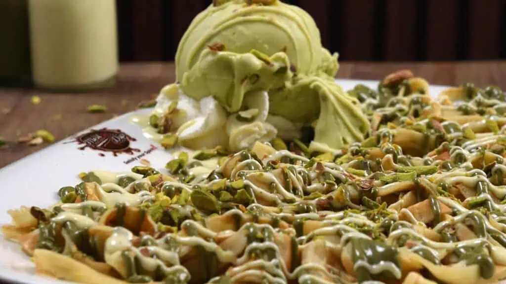 the fettuccine crepe cute in spirals and topped with pistachio